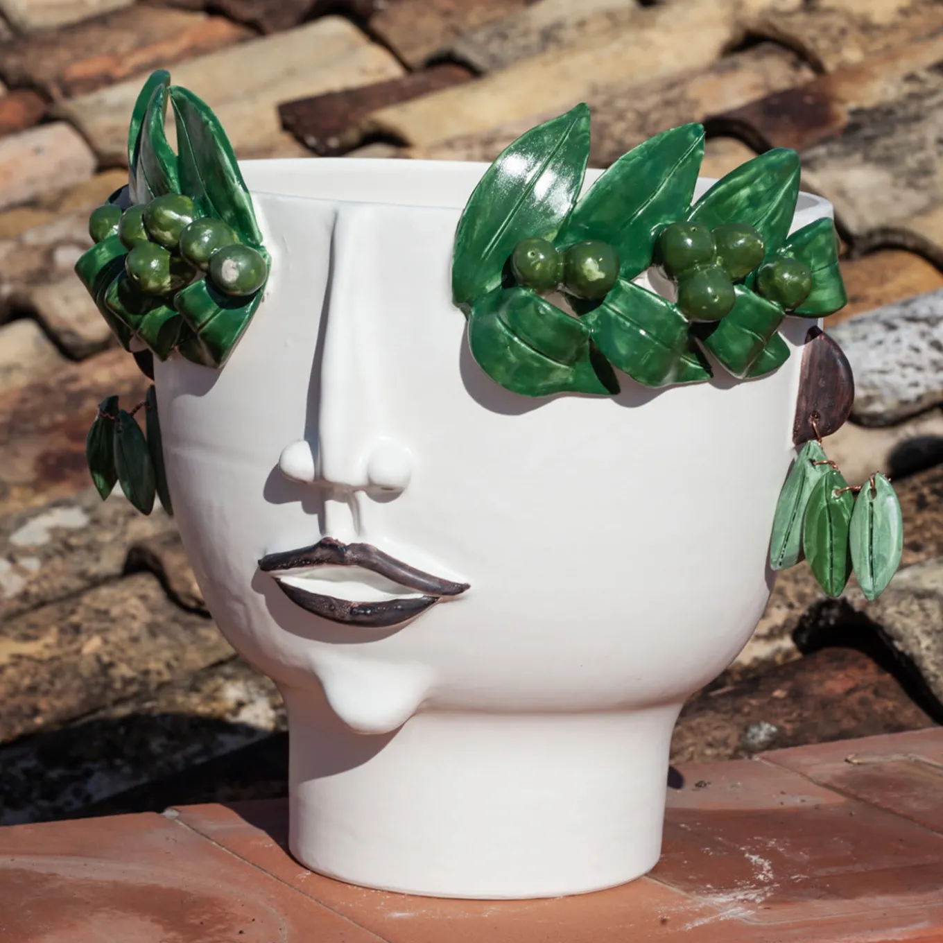 Vaso con testa di venditore di olio Oliva